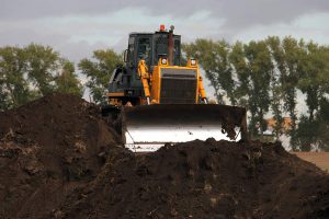 Bulldozer in Sand and soil— Excavator Services in Pink Lily, QLD